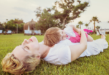 Image showing mother and little daughter playing at backyard