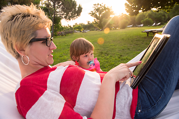 Image showing mom and a little daughter relaxing in a hammock