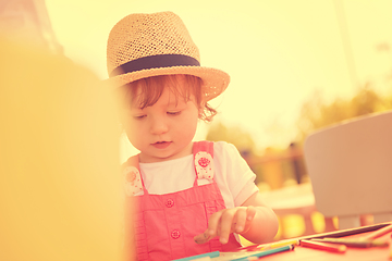 Image showing little girl drawing a colorful pictures