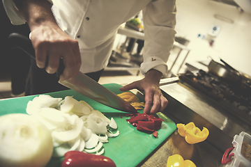 Image showing Chef hands cutting fresh and delicious vegetables