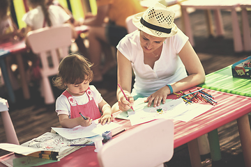 Image showing mom and little daughter drawing a colorful pictures