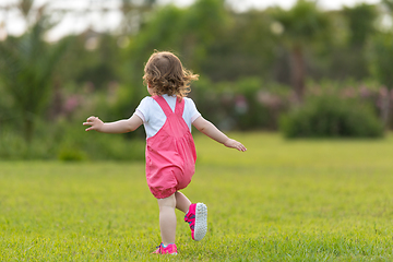 Image showing little girl spending time at backyard