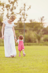 Image showing mother and little daughter playing at backyard