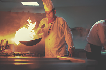 Image showing Chef doing flambe on food