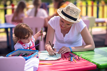 Image showing mom and little daughter drawing a colorful pictures