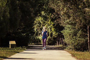 Image showing young female runner training for marathon