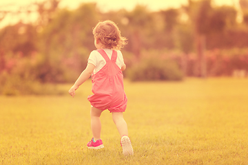 Image showing little girl spending time at backyard