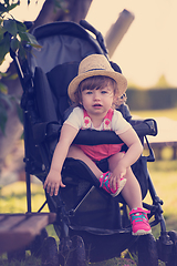 Image showing baby girl sitting in the baby stroller