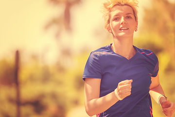 Image showing young female runner training for marathon