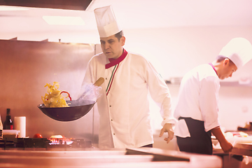 Image showing chef flipping vegetables in wok