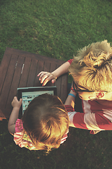 Image showing mom and her little daughter using tablet computer