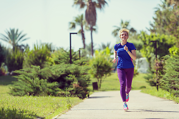 Image showing young female runner training for marathon