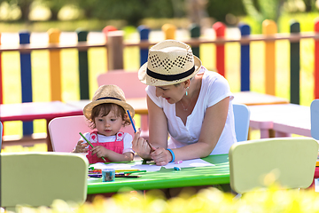 Image showing mom and little daughter drawing a colorful pictures