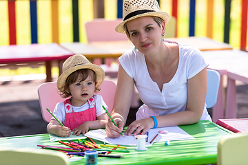 Image showing mom and little daughter drawing a colorful pictures