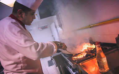 Image showing Chef doing flambe on food