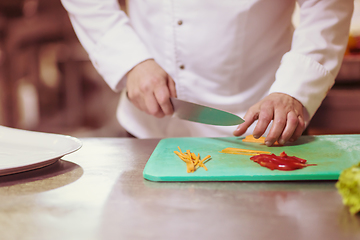 Image showing Chef hands cutting fresh and delicious vegetables