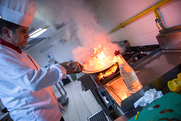 Image showing Chef doing flambe on food