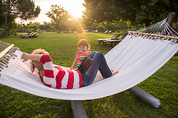 Image showing mom and a little daughter relaxing in a hammock