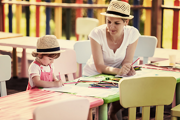 Image showing mom and little daughter drawing a colorful pictures