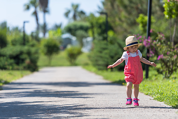 Image showing little girl runing in the summer Park