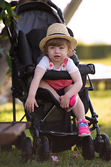 Image showing baby girl sitting in the baby stroller