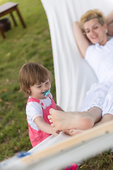 Image showing mother and a little daughter relaxing in a hammock