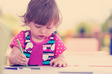 Image showing little girl drawing a colorful pictures