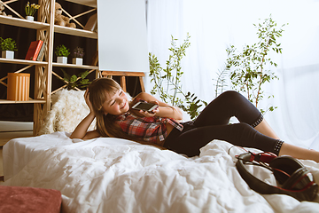 Image showing Little girl using different gadgets at home