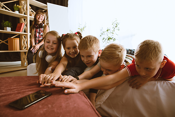 Image showing Little boys and girls using different gadgets at home