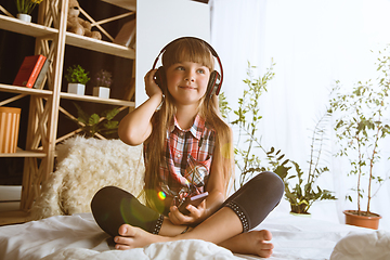 Image showing Little girl using different gadgets at home