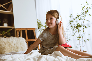 Image showing Little girl using different gadgets at home