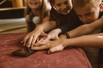 Image showing Little boys and girls using different gadgets at home