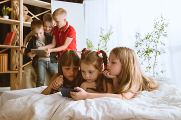 Image showing Little boys and girls using different gadgets at home