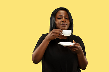 Image showing Young african woman isolated on yellow studio background, facial expression