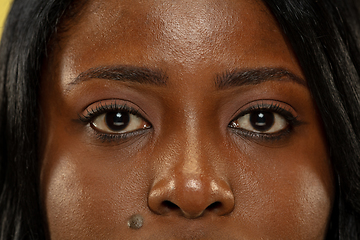 Image showing Young african woman isolated on yellow studio background, facial expression