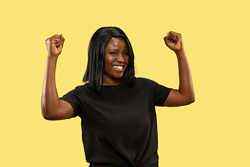 Image showing Young african woman isolated on yellow studio background, facial expression