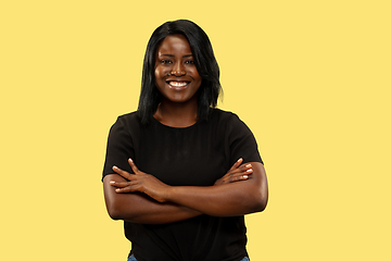 Image showing Young african woman isolated on yellow studio background, facial expression