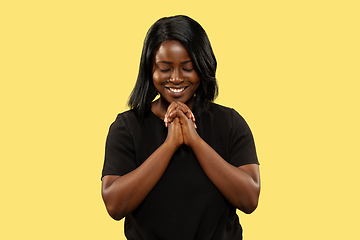 Image showing Young african woman isolated on yellow studio background, facial expression