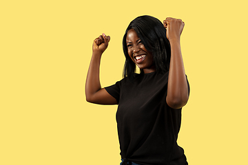 Image showing Young african woman isolated on yellow studio background, facial expression