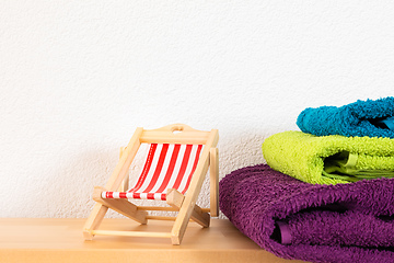 Image showing sunlounger and towels background
