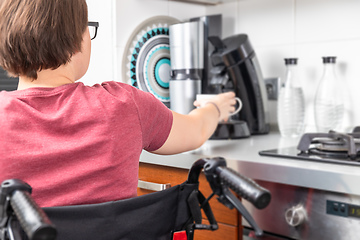 Image showing disabled woman getting coffee in the kitchen