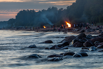 Image showing Unrecognisable people celebrating summer solstice with bonfires on beach