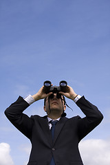 Image showing Businessman looking through binoculars