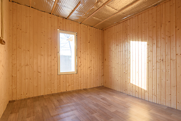 Image showing Empty room in a country house, sun rays fall on the wall from the window