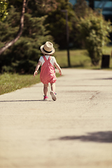 Image showing little girl runing in the summer Park