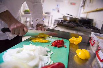 Image showing Chef hands cutting fresh and delicious vegetables