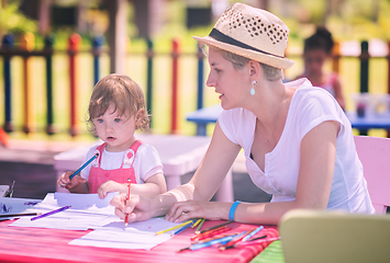 Image showing mom and little daughter drawing a colorful pictures