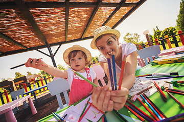 Image showing mom and little daughter drawing a colorful pictures