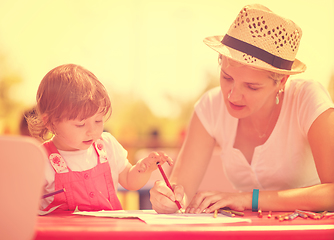 Image showing mom and little daughter drawing a colorful pictures