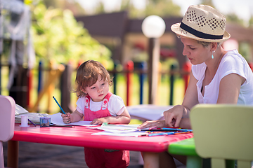 Image showing mom and little daughter drawing a colorful pictures